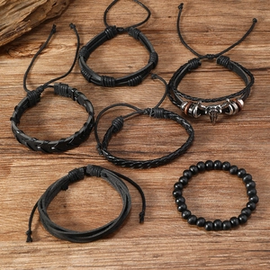 Detail view of 6-piece vintage men's leather bracelet set with metallic bull head charm