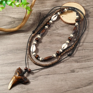 Handmade multi-layered shell and shark tooth necklace with tribal wooden beads