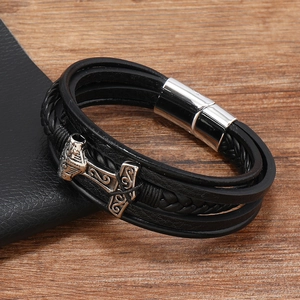 Detail of multi-layer black leather bracelet with silver Thor's Hammer charm and magnetic clasp