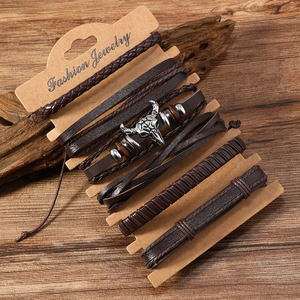 Detail view of 6-piece vintage men's leather bracelet set with metallic bull head charm