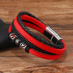 Detail of red and black braided leather bracelet with vintage metal beads and magnetic clasp