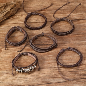 Detail view of 6-piece men's leather bracelet set with metallic bull head skull design