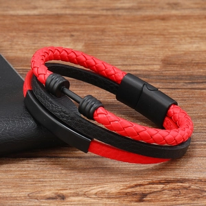 Close-up of red woven rope and black leather men's bracelet with a dumbbell charm