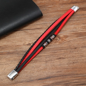 Detail of red and black braided leather bracelet with vintage silver alloy metal beads