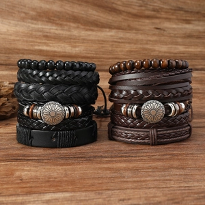 Detail view of 6-piece men's leather bracelets with metal sunflower on dark wood background