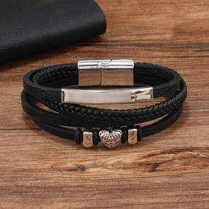 Detail of multi-layer braided leather bracelet with heart metal bead and magnetic clasp