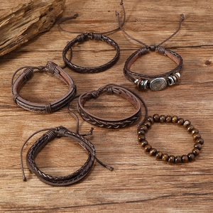 Detail of 6-piece men's leather bracelet set with woven cords and metal bull head