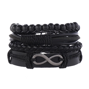 Macro detail of men's layered leather bracelet featuring infinity symbol and wooden beads