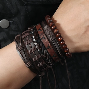 Detail of multi-layer leather bracelets with bull head charm and wooden beads on wrist