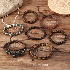 Detailed view of bohemian butterfly charm bracelets with woven leather and wooden beads
