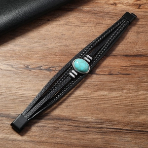 Close-up of vintage multilayer leather bracelet featuring a turquoise stone and metal clasp