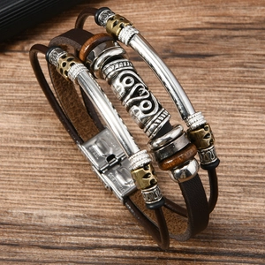 Detail of multi-layer leather bracelet featuring wood beads and stainless steel clasp