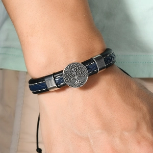 Detailed shot of multi-layer leather bracelet with silver Tree of Life charm and cord