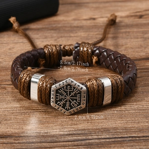 Detail of Viking Vegvisir compass charm on vintage braided leather bracelet for men