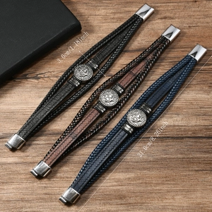Three multi-layer braided leather anchor bracelets with size specs on wood background