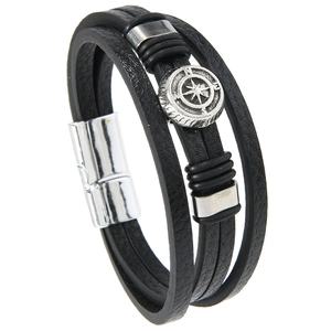 Detail of multi-layer black leather men's bracelet with silver compass charm and magnetic clasp
