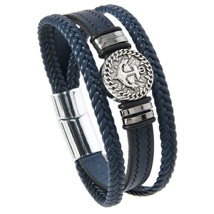 Detail of multi-layer navy braided leather bracelet with silver anchor magnetic clasp