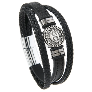 Detail of multi-layer braided leather bracelet featuring silver anchor plate and magnetic clasp