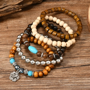 Handmade bohemian turquoise and wood bead bracelet set with silver flower charm