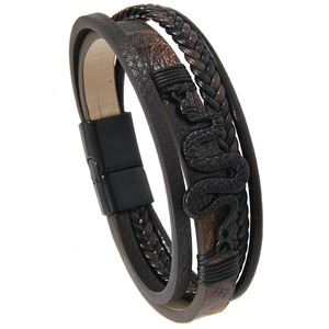 Close-up of multilayer braided leather bracelet with vintage snake charm and magnetic clasp