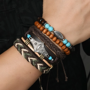 Macro detail of bohemian 6-piece bracelet set featuring wood beads and braided leather