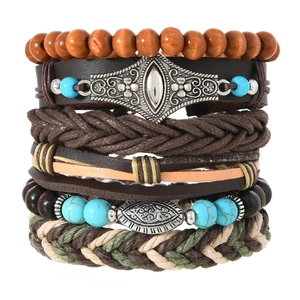 Detail of bohemian multilayer bracelet set with wood beads and ethnic charms on white base