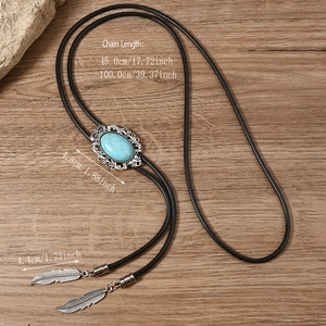 Detail of vintage bolo tie with blue turquoise slider and silver feather pendants