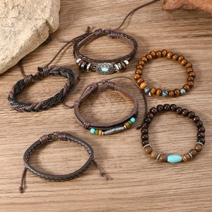Detail of bohemian multilayer bracelets with wooden beads and ethnic turquoise accents