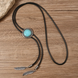 Detail of vintage bolo tie with blue turquoise stone and silver feather metal pendants
