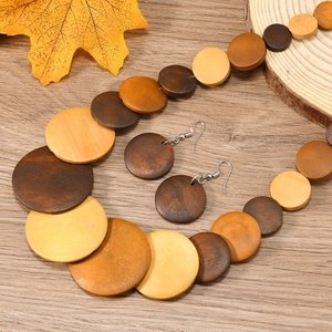 Bohemian retro wooden round pendant necklace and earrings set with autumn maple leaf background