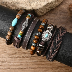 Detail of bohemian multilayer bracelets with wooden beads and turquoise accents