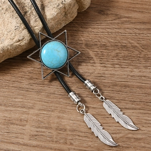 Macro detail of vintage bolo tie featuring a silver star frame with a blue turquoise stone