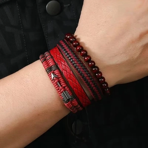 Detail of multi-layer handmade bracelets with red woven leather and beaded elements