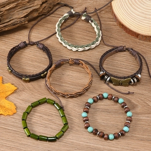 Detailed set of bohemian bracelets featuring turquoise beads, wooden charms, and leaf pendants