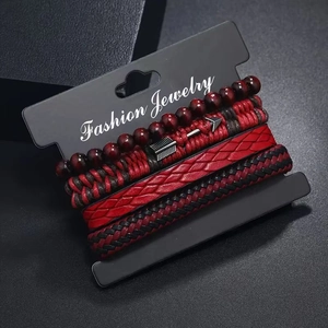 Close-up of four-piece vintage nautical bracelet set with leather weave and metal charms