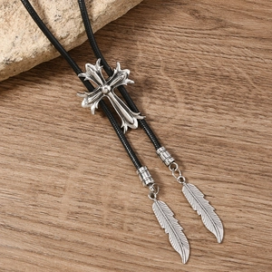 Vintage western bolo tie with silver cross, fleur-de-lis, and metal feather pendants