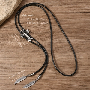 Detail of vintage silver cross bolo tie with black braided leather and feather tips