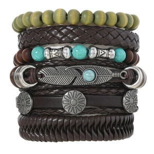 Detail of bohemian multilayer bracelet with wood beads, leather straps and feather charms