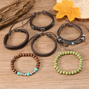 Close-up of Bohemian 6-piece bracelet set with turquoise, wood beads, and feather charms
