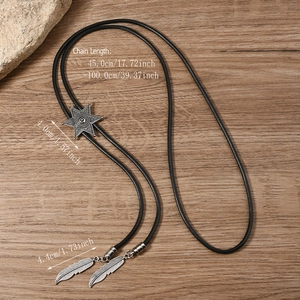 Detail of vintage star bolo tie with feather metal charms and braided black leather cord
