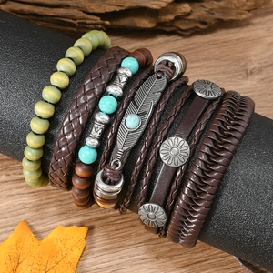 Detail view of Bohemian multilayer bracelets featuring turquoise beads and feather charms