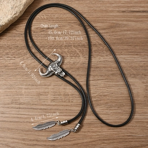 Western vintage bolo tie featuring a silver bull skull pendant and metal feather tips