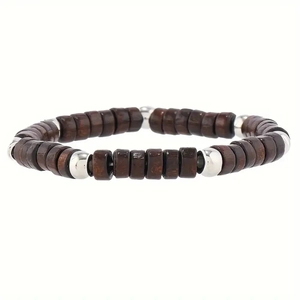 Detail of wooden beads and silver metallic spheres on a handcrafted layered bracelet