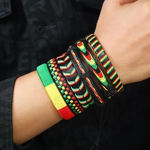 Macro shot of vintage men's braided leather bracelet set in rasta red yellow green colors