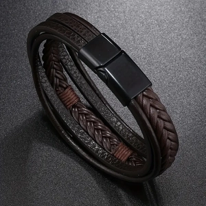 Close-up of multilayer dark brown braided leather bracelet with black magnetic metal clasp