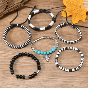Detail view of Bohemian multi-layer bracelets with blue turquoise, wood beads and bull charm