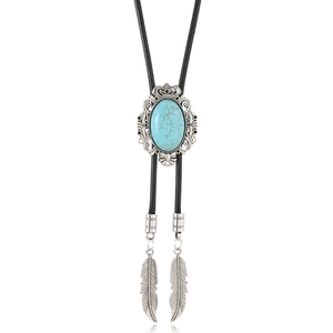 Detail of vintage Western bolo tie featuring turquoise stone and silver flower carving