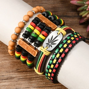 Detail of Rasta style multilayer bracelets with wooden beads and cannabis leaf metal plate