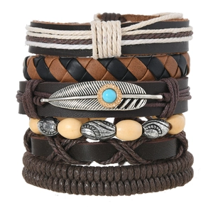 Detail of bohemian multilayer bracelet set with turquoise feather charm and wooden beads