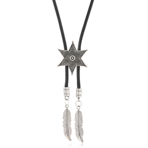 Detail of western bolo tie featuring a silver hexagram slider and metal feather pendants